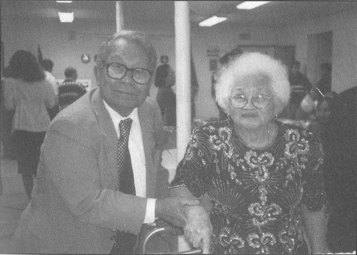 Rev. Vicente Onggao and Mrs. Angeles Onggao seated together, holding hands.